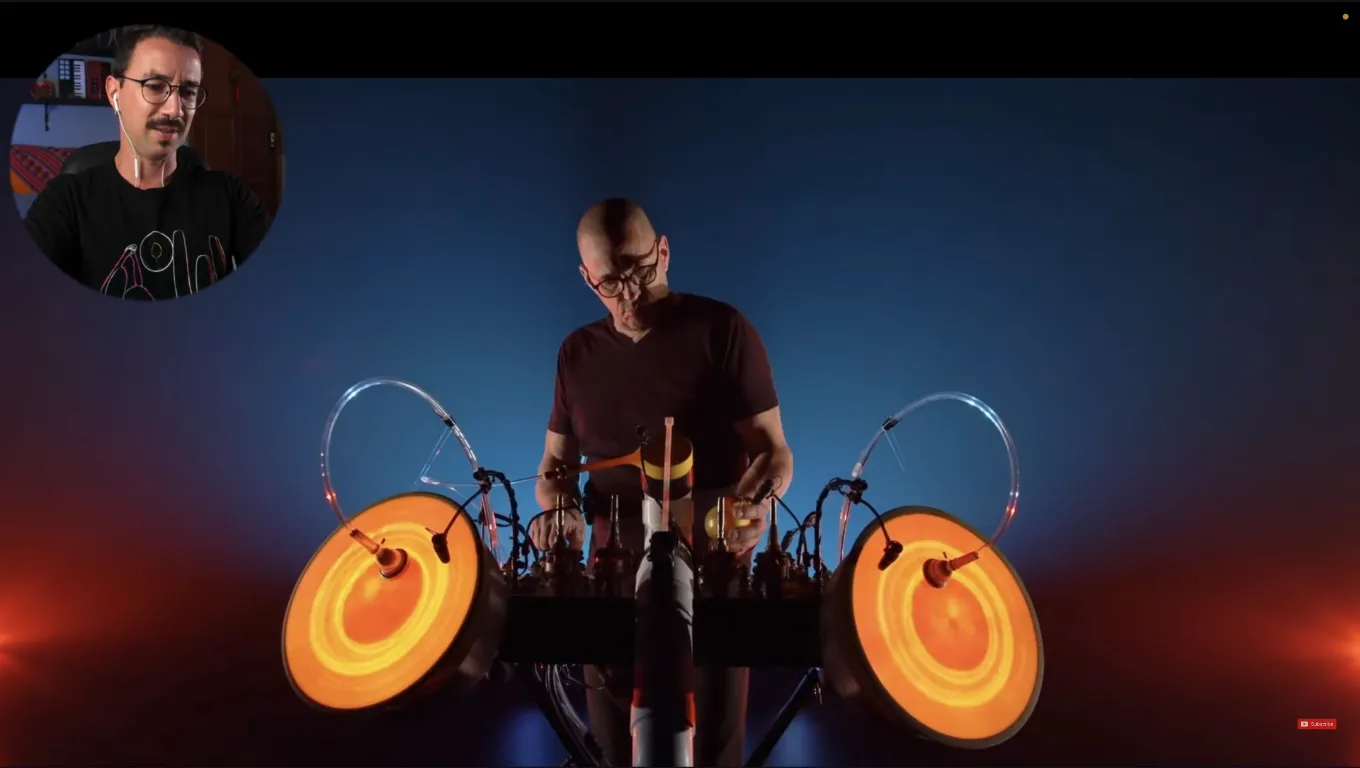 A performer plays the Babel Table, a large instrument with circular illuminated surfaces.