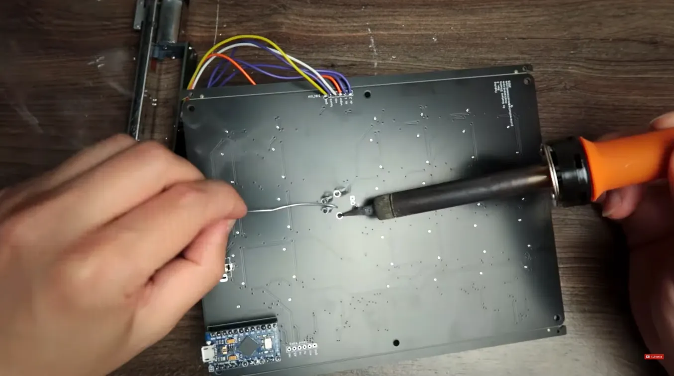 Work on the underside of the Faduino board during assembly.